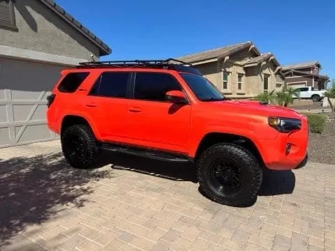 Lifted red Toyota 4Runner on all-terrain tires