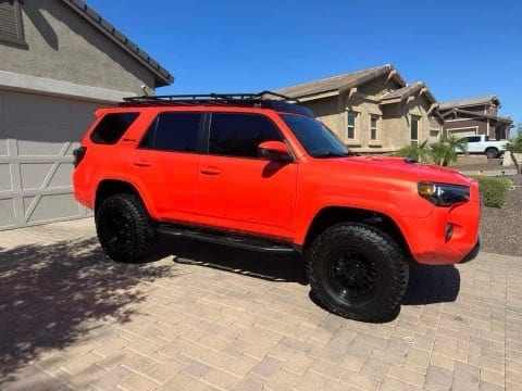 Lifted red Toyota 4Runner on all-terrain tires