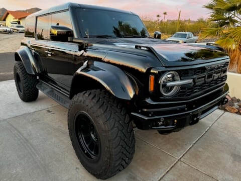 Blacked-out Ford Bronco Raptor detailed at sunset