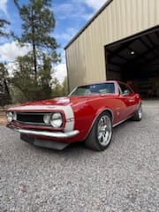 Red 1967 Chevrolet Camaro outside the shop