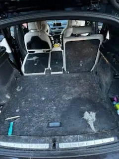Dirty SUV cargo area before interior deep clean