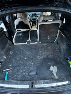 Dirty SUV cargo area before interior deep clean
