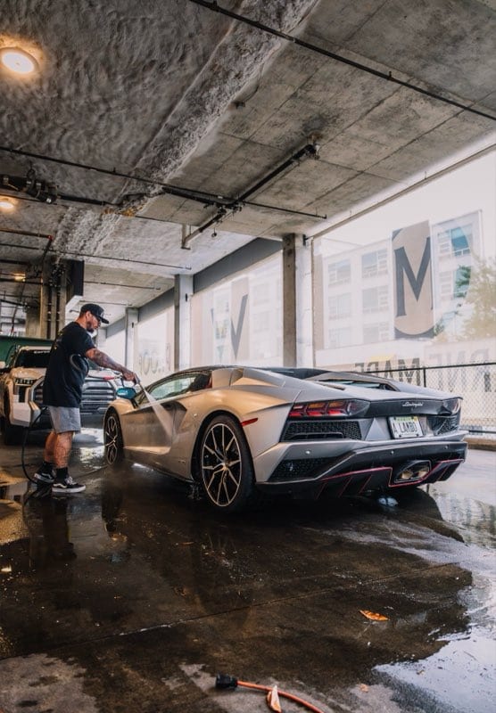 Nico washing a silver Lamborghini Aventador