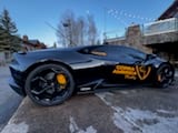 Black Lamborghini at a winter rally stop