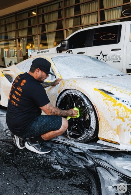 Nico detailing the wheels of a foamed rally supercar
