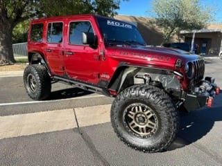 Red Jeep Wrangler Unlimited, lifted and trail-ready